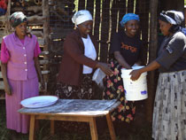 Photo: Doris (centre right) packing cakes with her College Tree Nursery Group Members