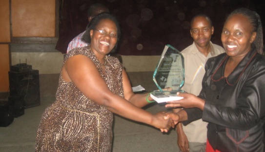 Ms. Jedidah, Vice Chair (GBM Board) presenting an Award to the winning school