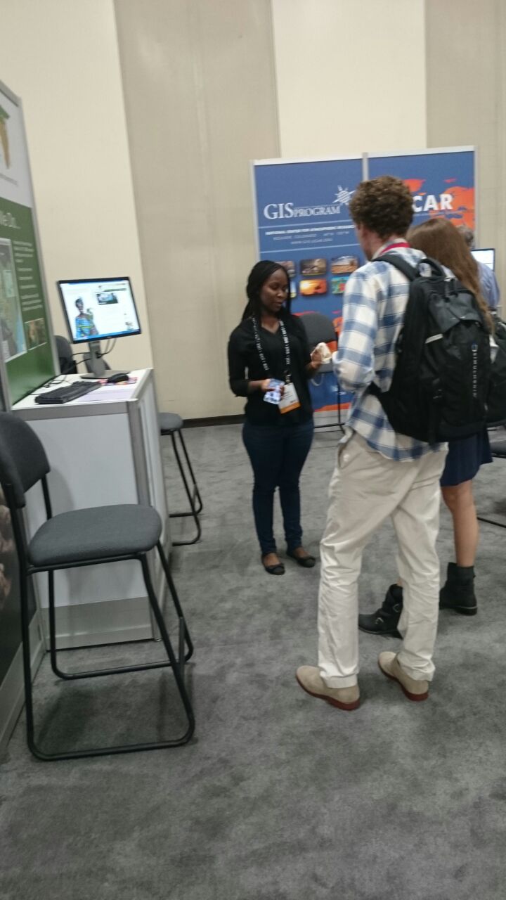 GBM's Nancy Neema (in black) speaks to some attendees who visited GBM's booth at the conference